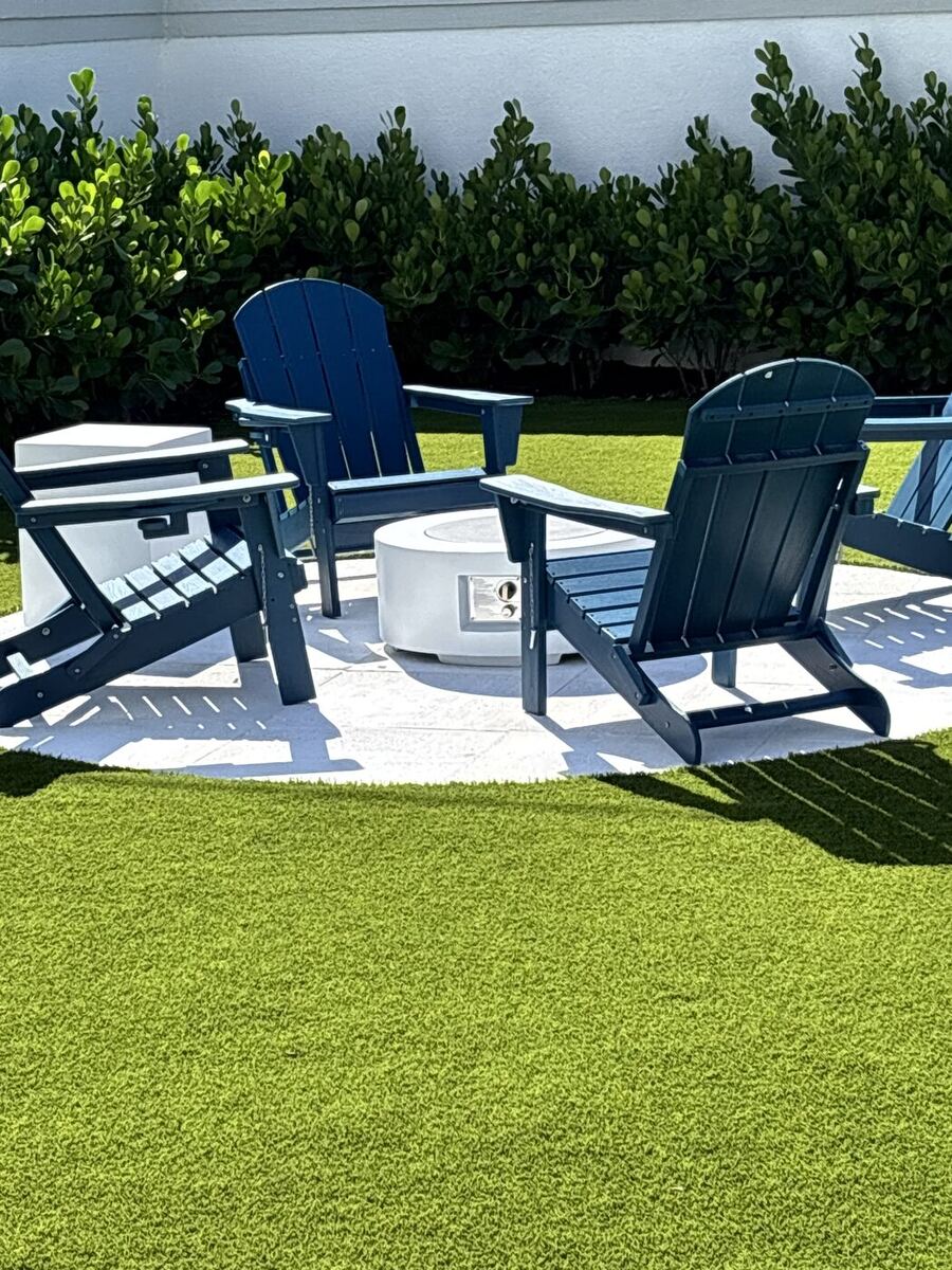 Backyard with artificial turf, paver seating circle, fire pit and Adirondack chairs